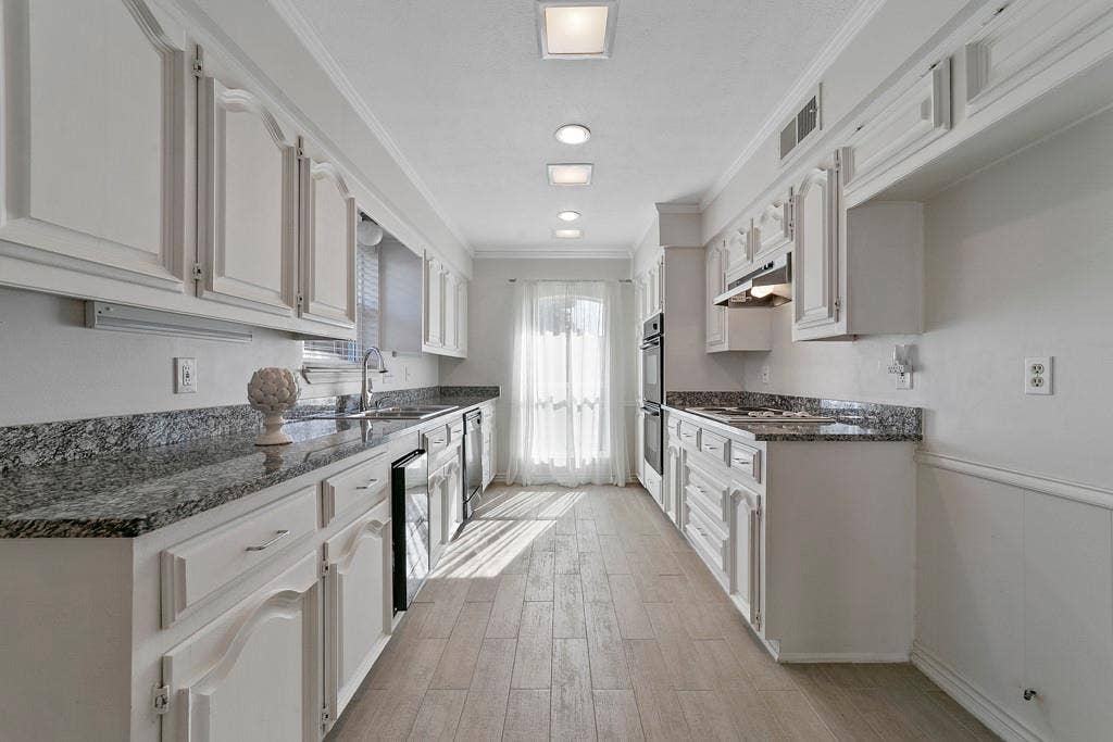 16353 Lauder Lane, Dallas, TX 75248 White cabinetry with decorative trim, granite countertops, tile flooring, recessed ceiling lighting, and a built-in double oven