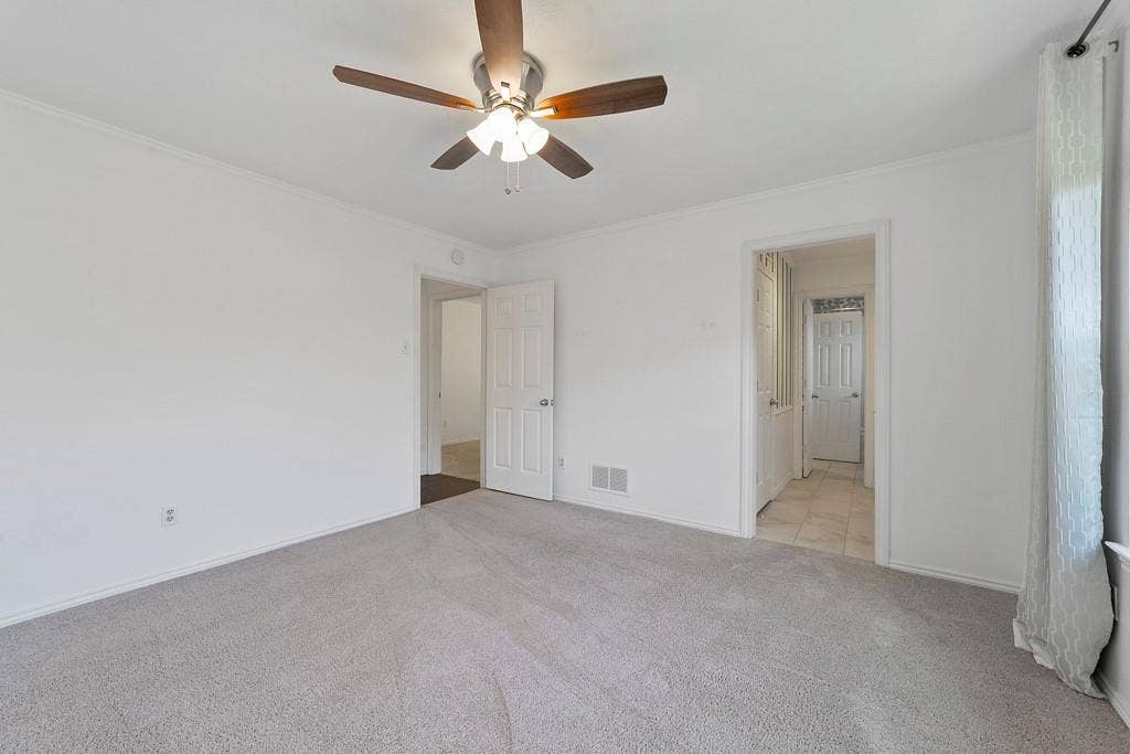 16353 Lauder Lane, Dallas, TX 75248 Light gray carpet flooring, white walls, ceiling fan with integrated lighting, white trim, and a white paneled door