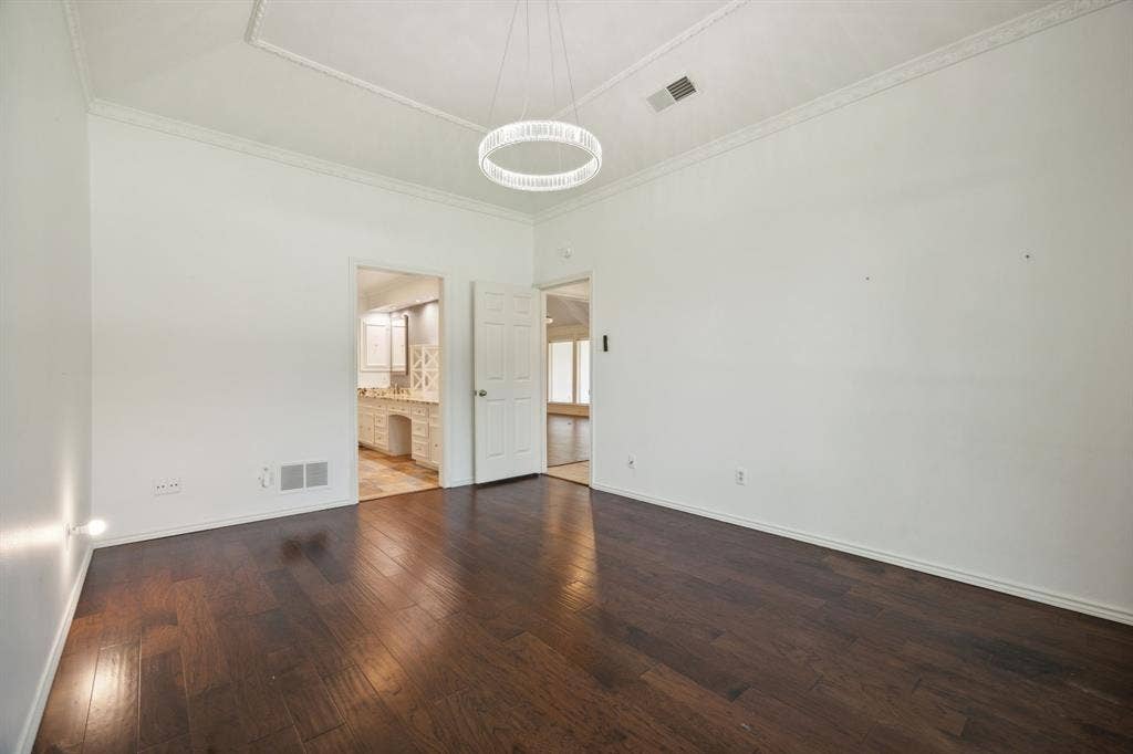 16353 Lauder Lane, Dallas, TX 75248 Rich wood-finish flooring, crisp white walls, and a recessed ceiling with crown molding