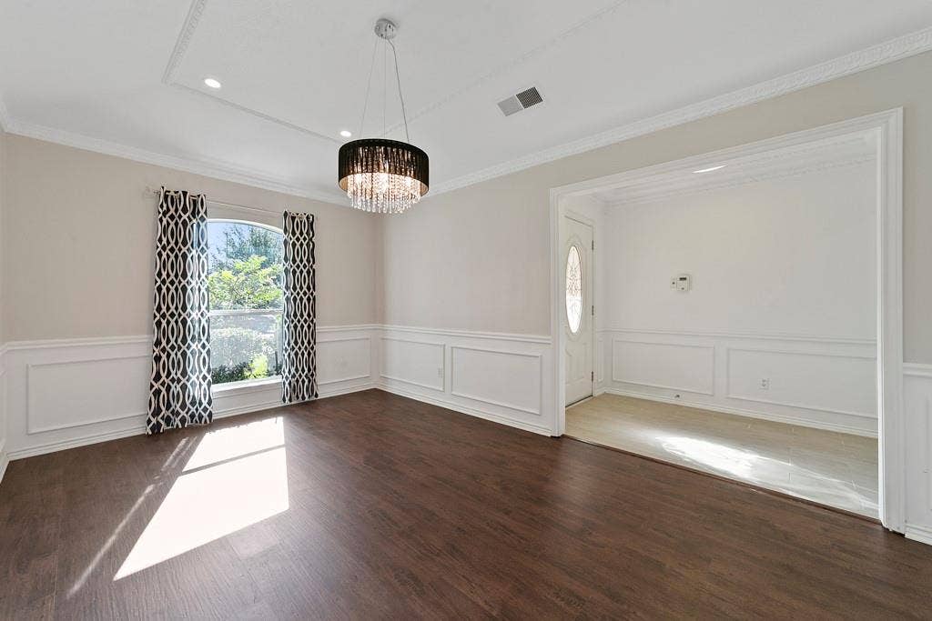 16353 Lauder Lane, Dallas, TX 75248 Dark wood-finish flooring with white wainscoting and crown molding