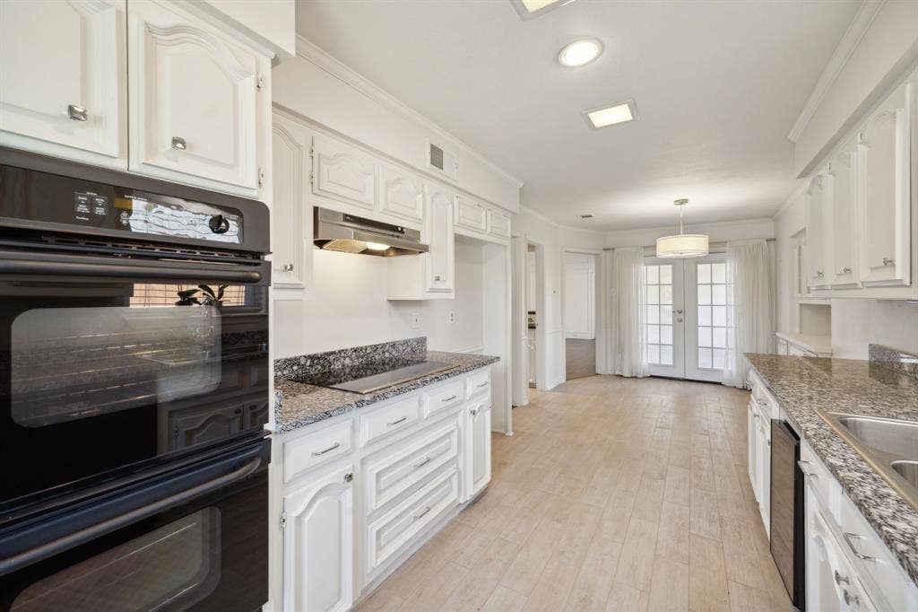 16353 Lauder Lane, Dallas, TX 75248 Kitchen featuring white cabinetry, stone countertops, a built-in oven, and wood-finish flooring