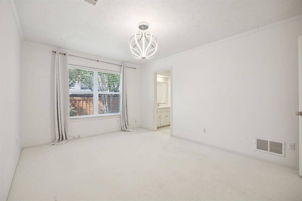 16353 Lauder Lane, Dallas, TX 75248 Recessed window with blinds, overhead decorative light fixture, and light-colored carpeting