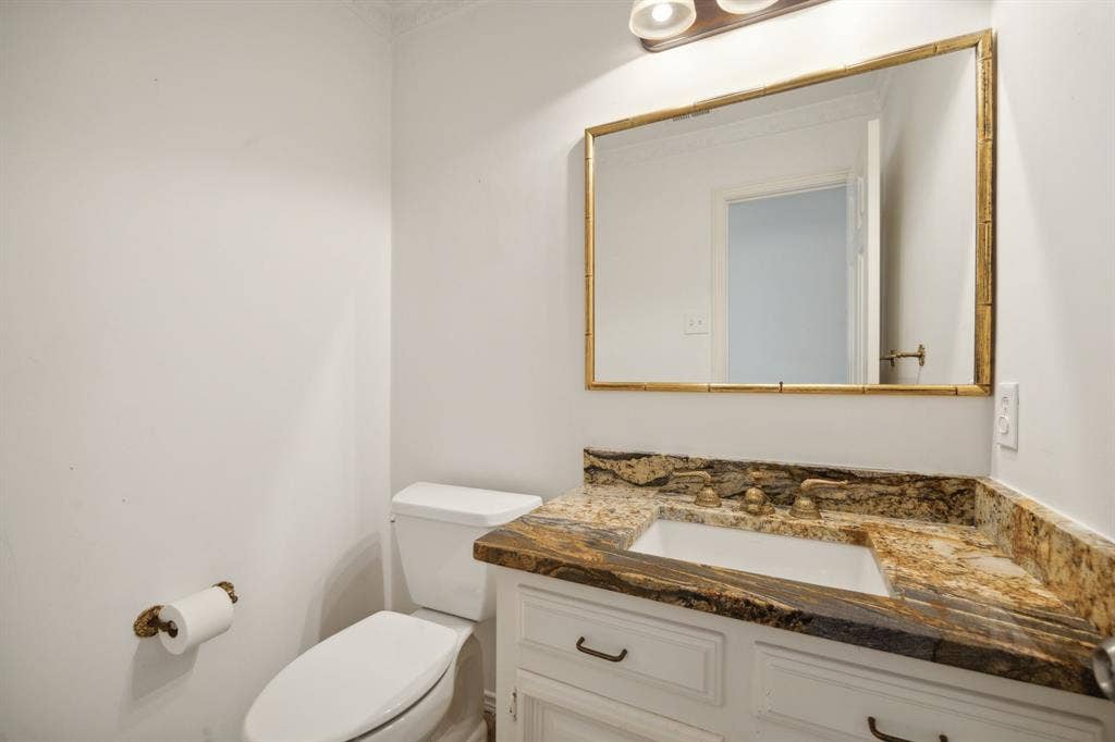 16353 Lauder Lane, Dallas, TX 75248 White vanity with under-mount sink, detailed countertop, and gold-framed mirror
