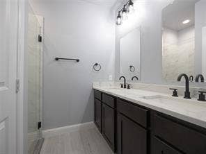 Ensuite bathroom to primary bedroom with shower and double sinks.