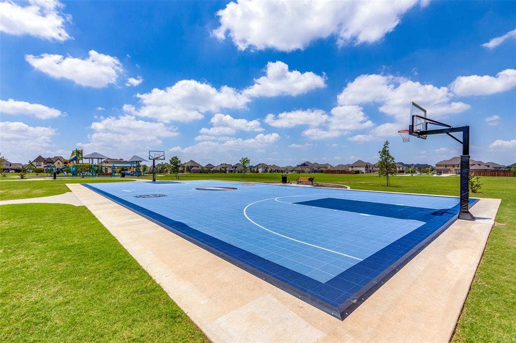 1481 Ramsbury Lane, Prosper, TX 75078 Multi-sport court with blue surfacing, featuring a basketball hoop and paved perimeter