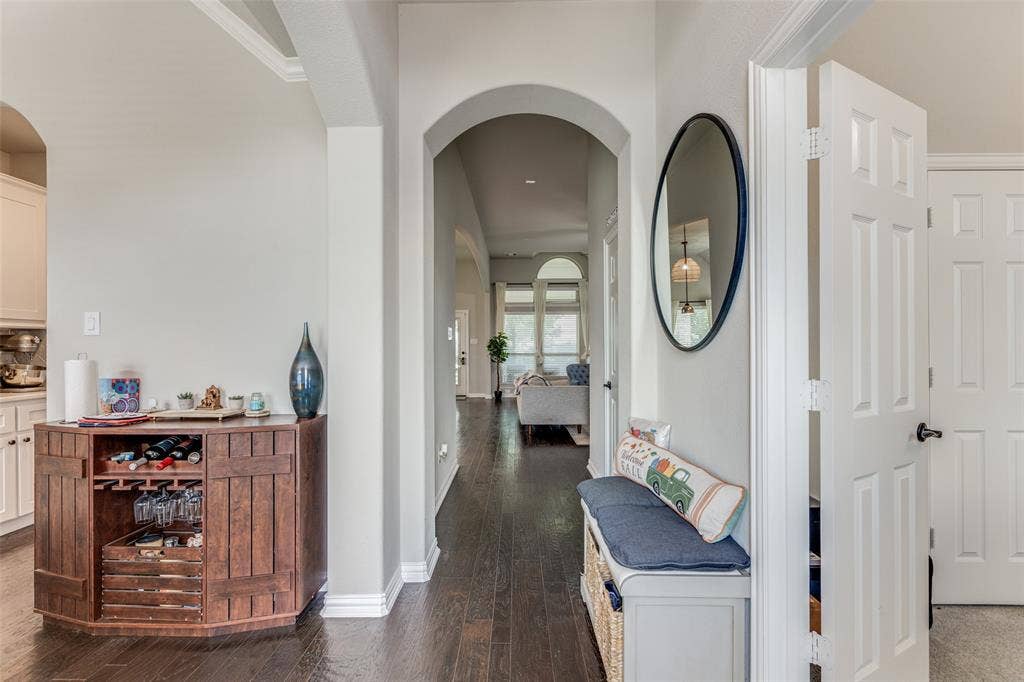 1481 Ramsbury Lane, Prosper, TX 75078 Hardwood-finish flooring, arched doorways, white interior doors, and crown molding