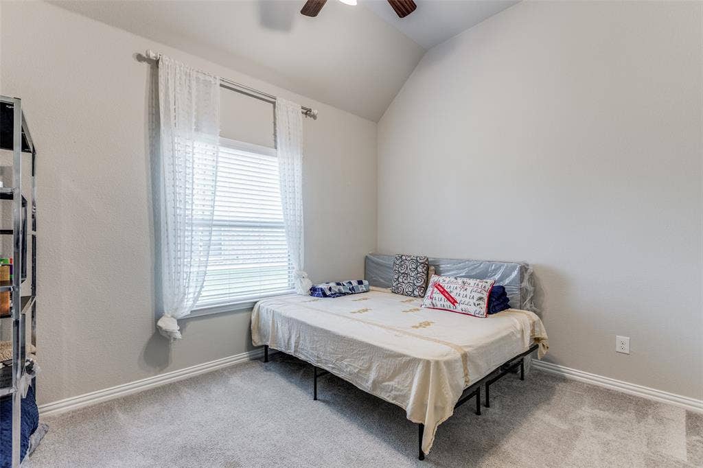 1481 Ramsbury Lane, Prosper, TX 75078 Vaulted ceiling, ceiling fan, window with blinds, carpet flooring, and neutral wall paint