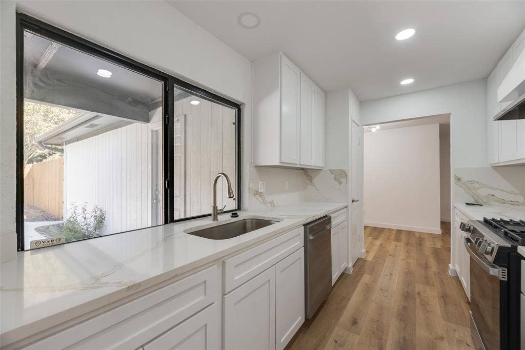 1903 Clemson Drive, Richardson, TX 75081 Kitchen featuring white cabinetry, stone countertops, stainless steel appliances, wood-finish flooring, and recessed lighting