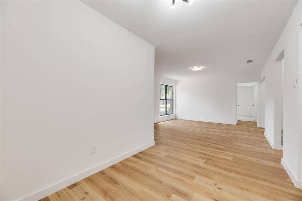 1903 Clemson Drive, Richardson, TX 75081 Wood-finish flooring, white walls, and a ceiling-mounted light fixture