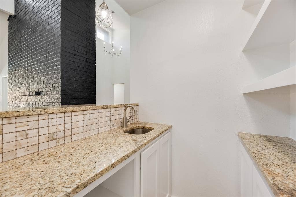 1903 Clemson Drive, Richardson, TX 75081 Granite countertops, integrated sink, tiled backsplash, white cabinetry, and open shelving