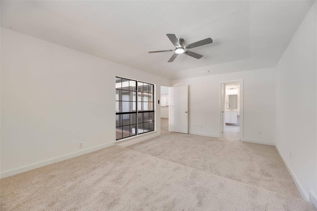 1903 Clemson Drive, Richardson, TX 75081 Spacious room with carpet flooring, a multi-pane window, and a contemporary ceiling fan
