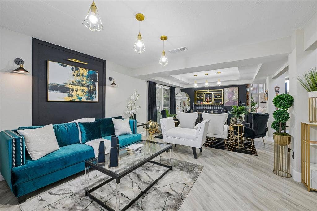Spacious interior with light wood-finish flooring, recessed lighting, and a tray ceiling