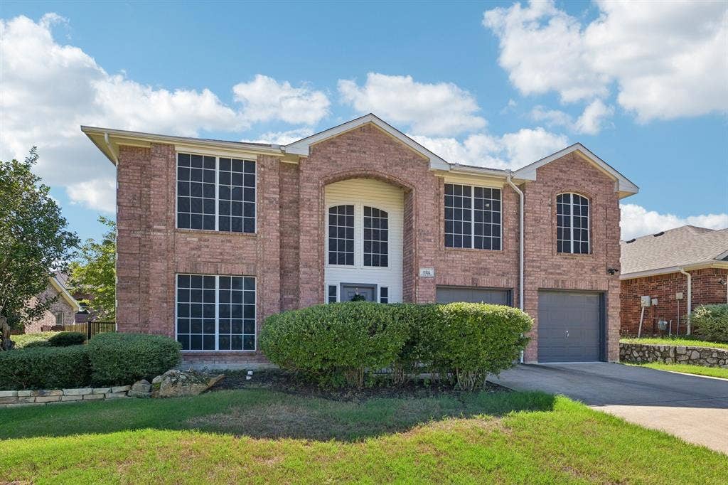 Brick exterior with multiple gables and arched window accents