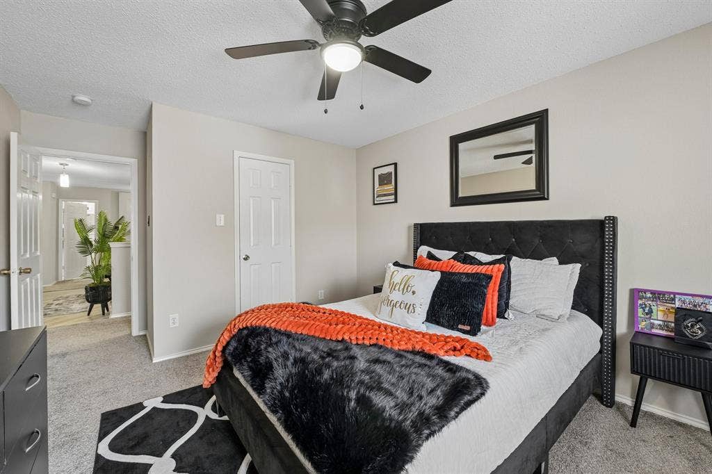 Neutral-toned walls complement the carpeted flooring