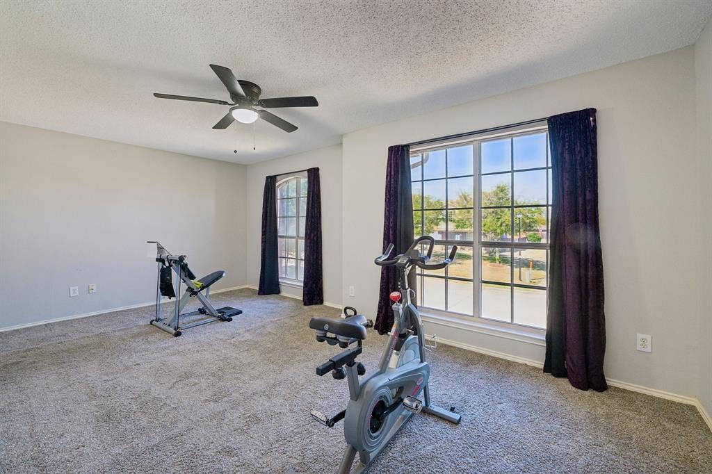 Recessed ceiling fan with integrated lighting, two multi-pane windows, and neutral wall paint