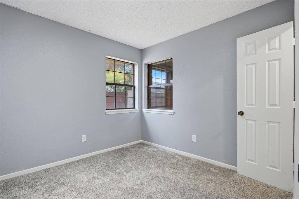 Textured gray carpet and light gray wall paint