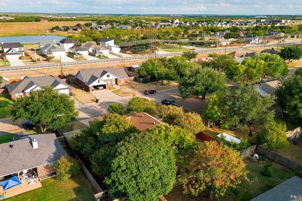 Aerial perspective showcasing residential properties with varied rooflines and mature trees