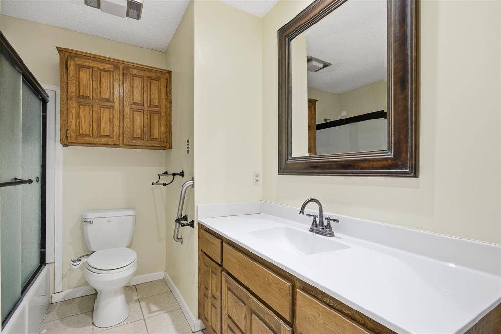 White vanity countertop with integrated sink and dark-toned faucet
