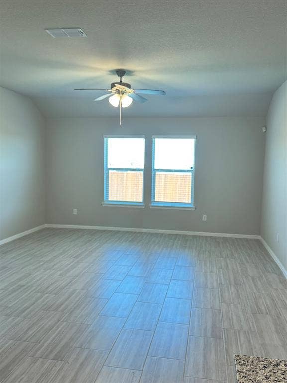 Unfurnished living room with a ceiling fan and wood finish floors