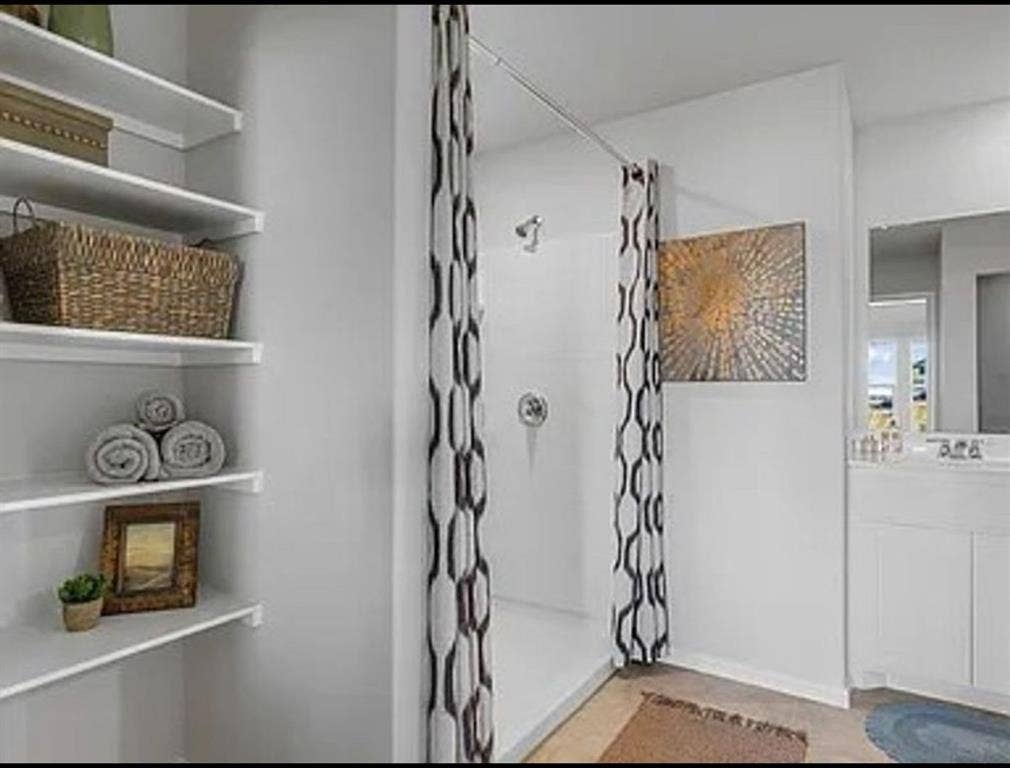 Full bath with a stall shower and vanity