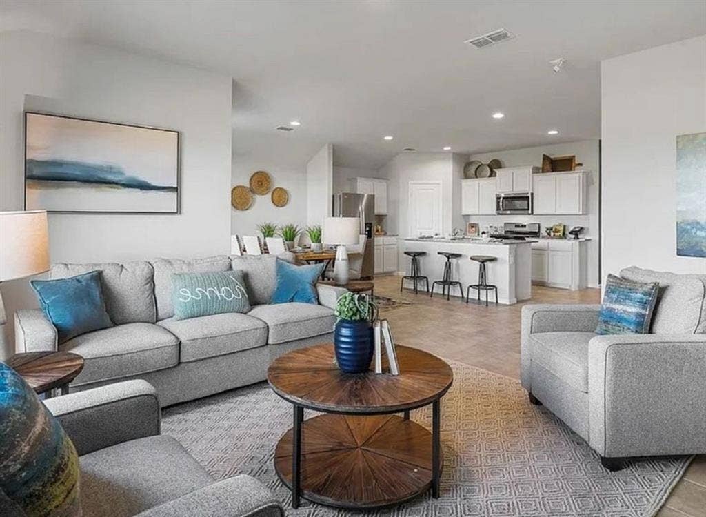 Staged Living room featuring recessed lighting.  Home is currently vacant.