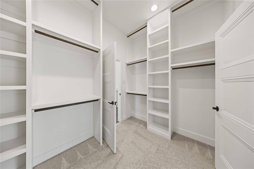 104 Oak Meadow Lane, Weatherford, TX 76085 Built-in shelving, white cabinetry, integrated hanging rods, recessed lighting, and carpeted flooring