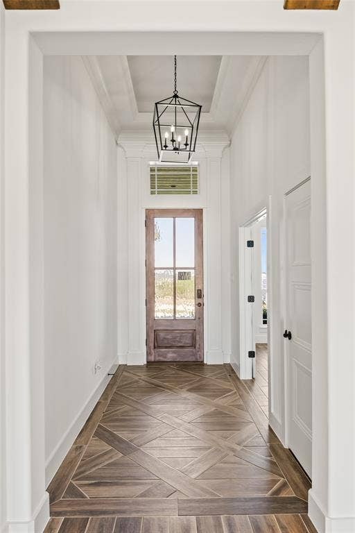 104 Oak Meadow Lane, Weatherford, TX 76085 Entryway featuring wood-finish flooring with a decorative pattern, a wood-finish door with glass panels, a transom window, and a coffered ceiling with a black lantern-style chandelier