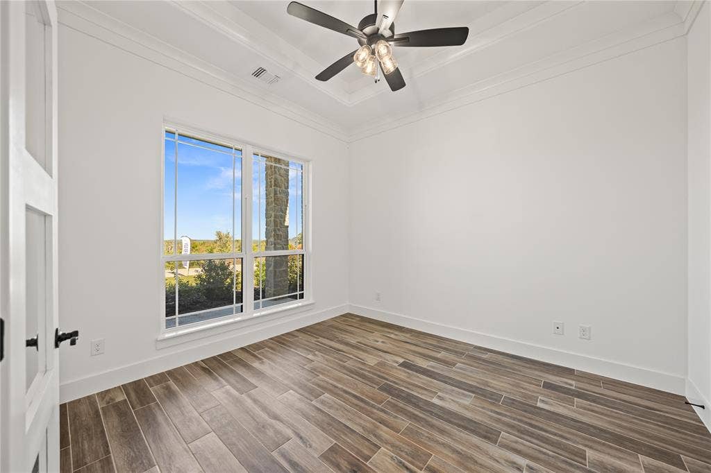 104 Oak Meadow Lane, Weatherford, TX 76085 Wood-finish flooring, white walls, and a multi-pane window