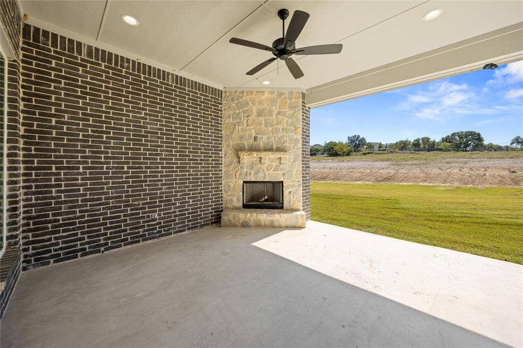 104 Oak Meadow Lane, Weatherford, TX 76085 Covered outdoor patio with a stone-clad fireplace and hearth