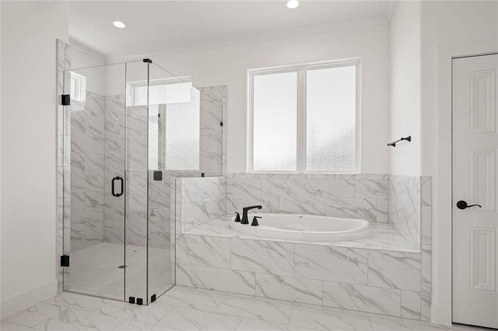 104 Oak Meadow Lane, Weatherford, TX 76085 Walk-in shower with clear glass enclosure, built-in soaking tub, tile surround, and matte black fixtures