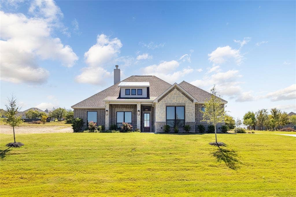 104 Oak Meadow Lane, Weatherford, TX 76085 Brick and stone exterior featuring a prominent front gable, a dormer with three windows, and a covered entry
