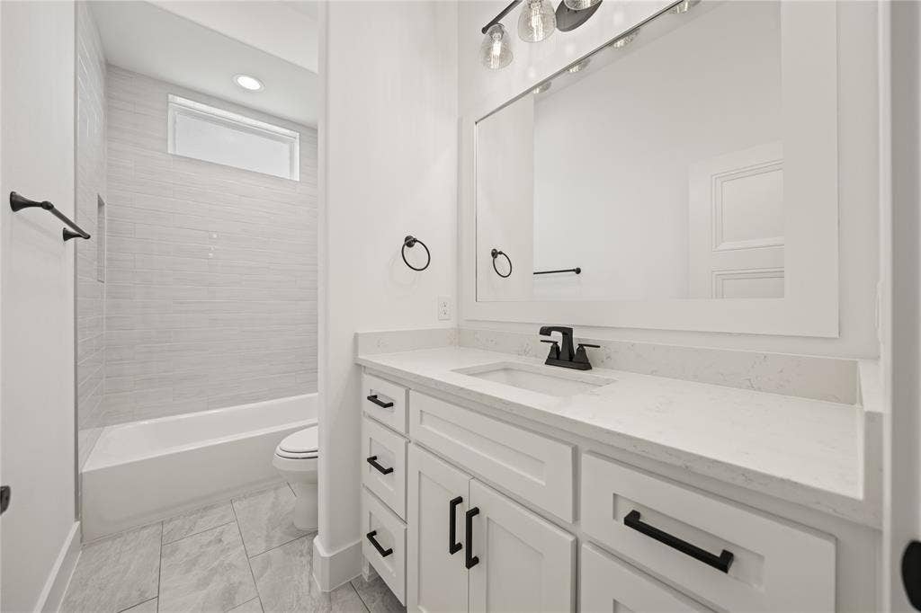 104 Oak Meadow Lane, Weatherford, TX 76085 White shaker cabinetry with matte black hardware, white rectangular sink, light-toned countertop, and framed mirror