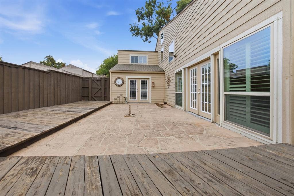 Outdoor patio featuring a stamped concrete surface and a wooden deck