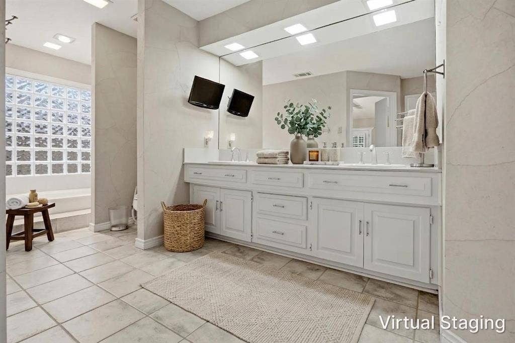 Dual vanity with white cabinetry, square vessel sinks, and integrated mirror