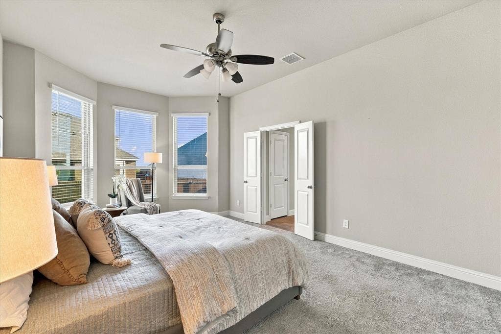 Recessed window bay, ceiling fan with integrated lighting, double-door entryway, and light-toned wall finishes