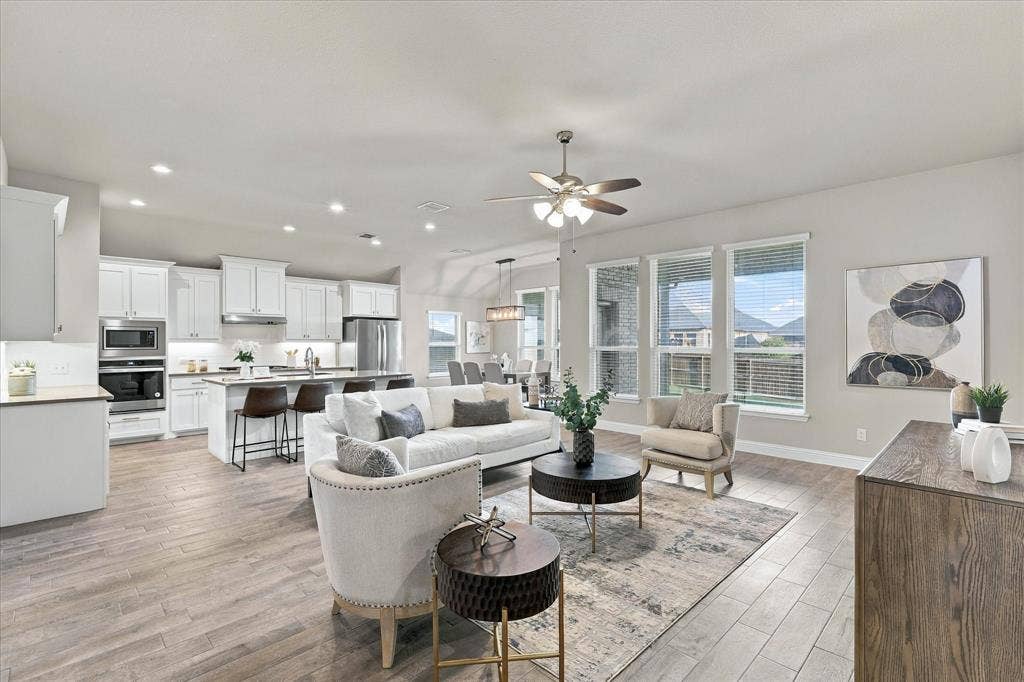Open-concept living area featuring wood-finish flooring, recessed lighting, and a ceiling fan