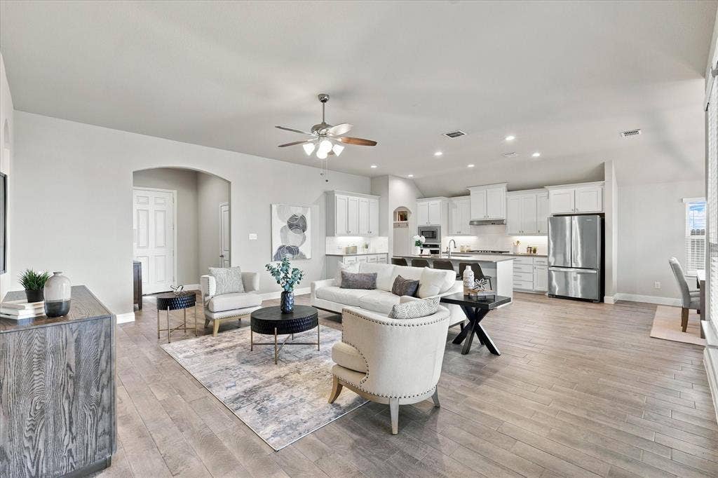 Open-concept living area featuring wood-finish flooring, recessed lighting, and a ceiling fan