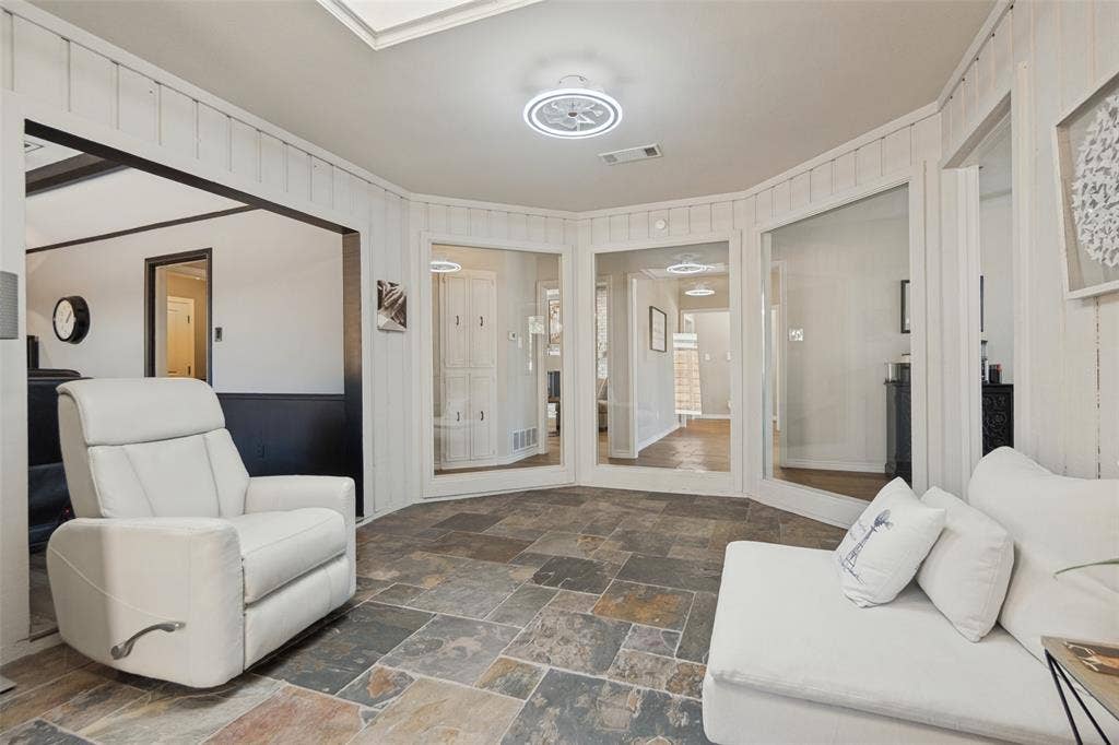 7414 Windmill Lane, Garland, TX 75044 Natural stone tile flooring with a neutral color palette