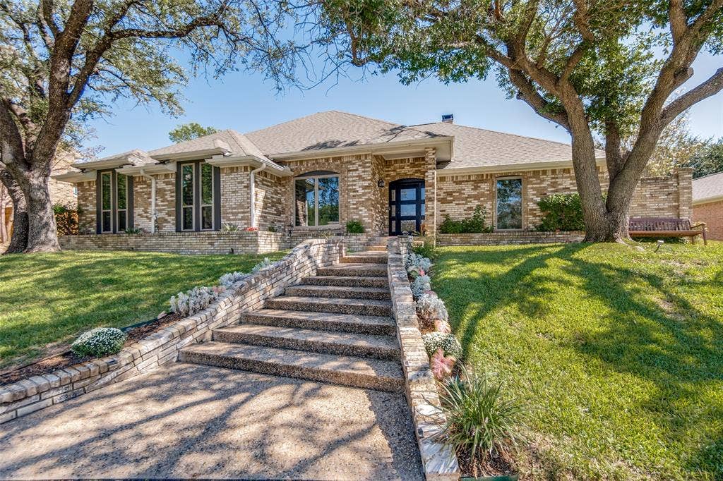 7414 Windmill Lane, Garland, TX 75044 Brick exterior with a gabled roofline