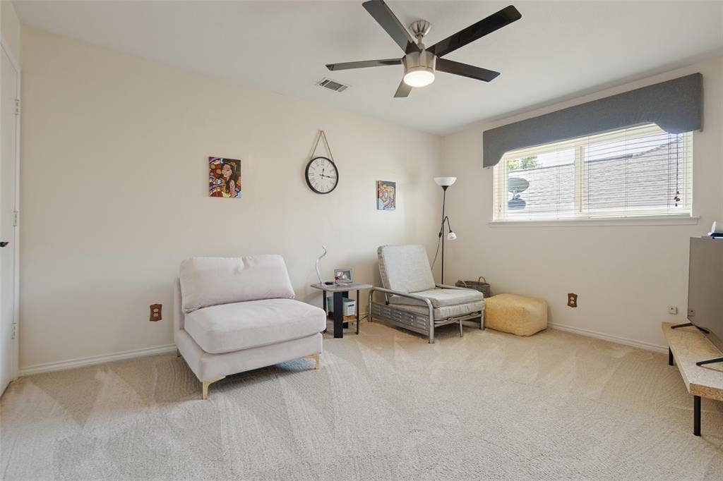 7414 Windmill Lane, Garland, TX 75044 Neutral wall paint, ceiling fan, window with blinds, and light-toned carpeting