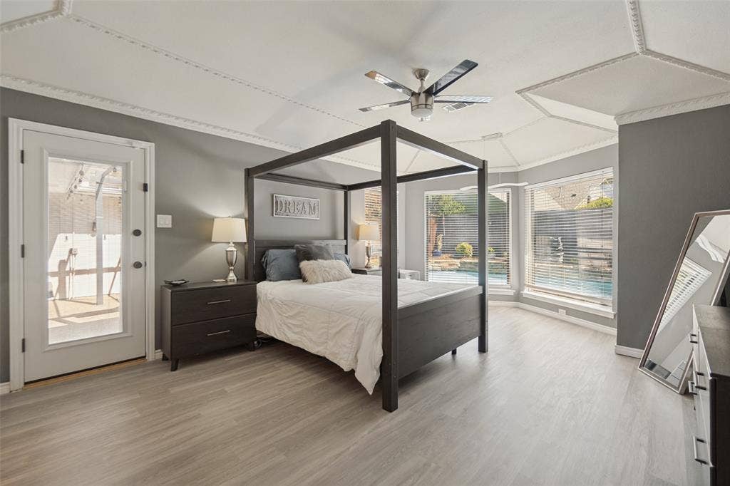 7414 Windmill Lane, Garland, TX 75044 Tray ceiling with decorative molding, ceiling fan, wood-finish flooring, and bay windows