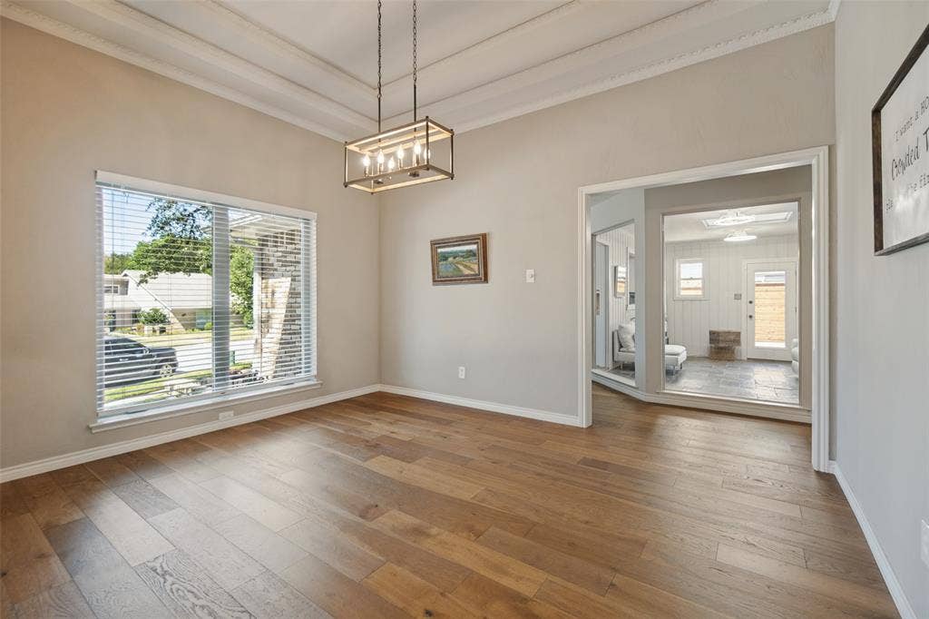 7414 Windmill Lane, Garland, TX 75044 Wood-finish flooring, coffered ceiling, recessed lighting, and a large window with blinds
