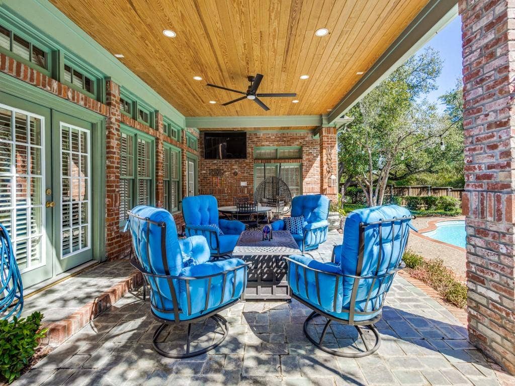 Covered patio with a wood-plank ceiling, recessed lighting, and a ceiling fan