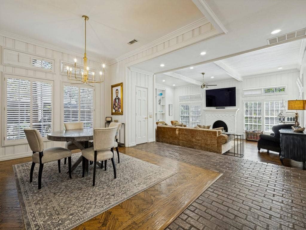 Open-concept living area with white paneled walls and a coffered ceiling