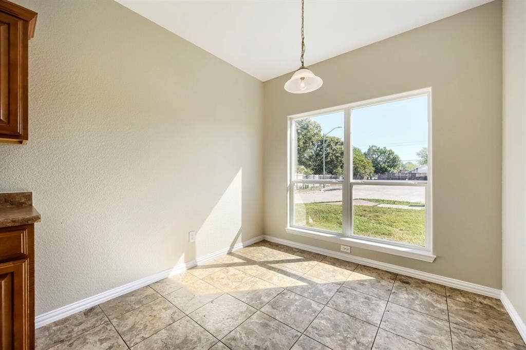 Tile flooring, recessed lighting, built-in cabinetry, and a large window