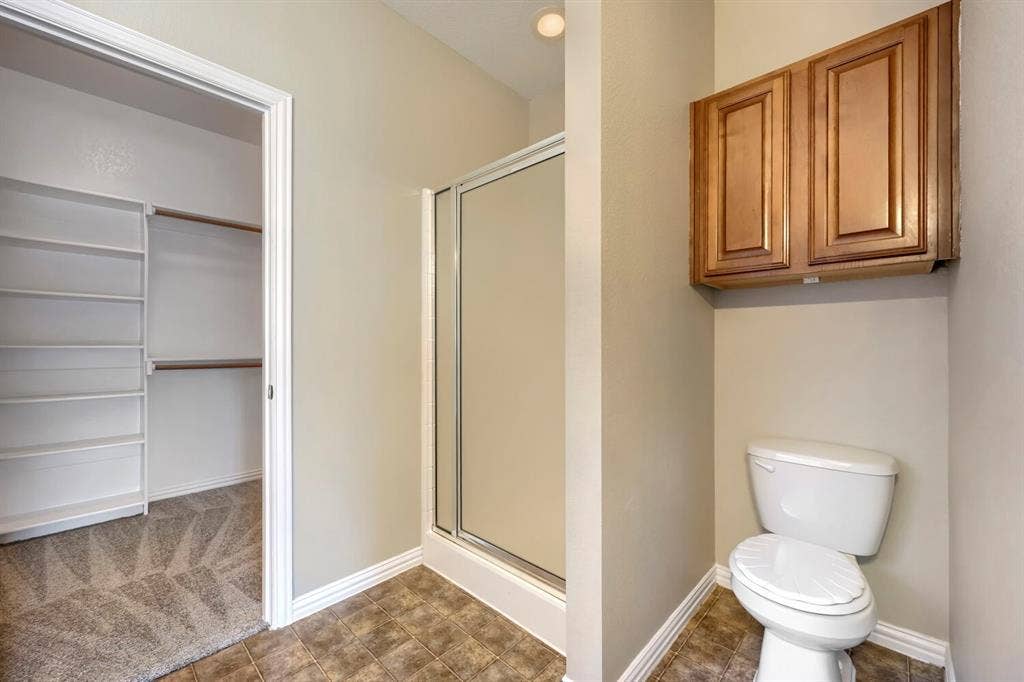 Walk-in closet with built-in shelving and hanging rods