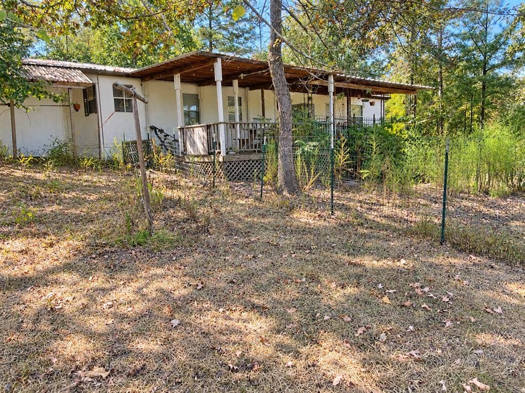 Covered porch with exposed wood beams and decking