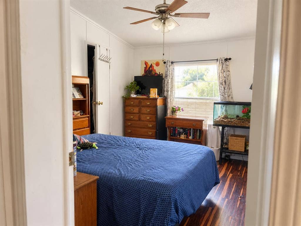 Wood-finish flooring with white paneled walls