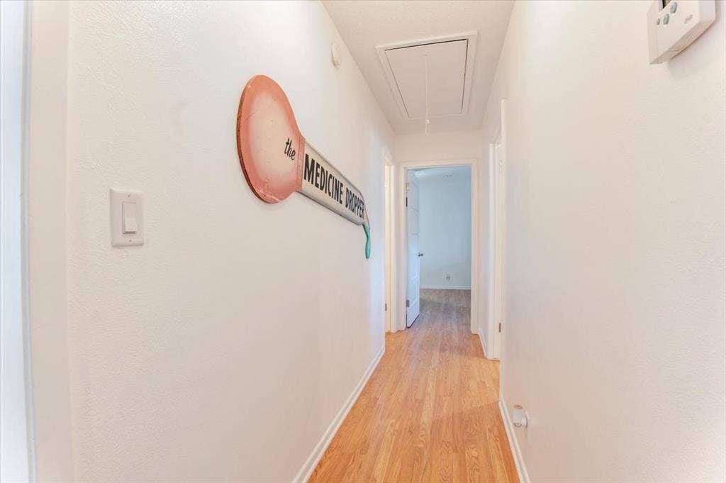 Wood-finish flooring throughout the hallway