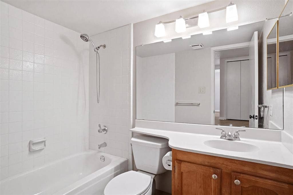 White tiled shower and tub combination